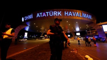 A riot police officer stands guard at the entrance of the Ataturk airport in Istanbul, Turkey, following a multiple suicide bombing, early June 29, 2016. REUTERS/Murad Sezer