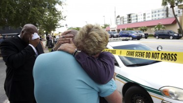 Terry DeCarlo, executive director of the LGBT Center of Central Florida, center, is comforted by Orlando City Commissioner Patty Sheehan, right, after a shooting involving multiple fatalities at a nightclub in Orlando, Fla., Sunday, June 12, 2016. (AP Photo/Phelan M. Ebenhack)